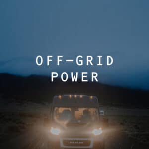 OG Campervan driving on a dirt road at night with headlights on. 